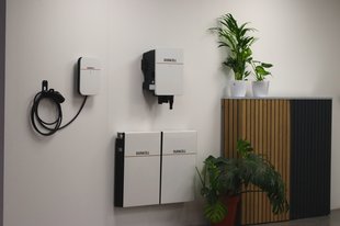 Wall-mounted home energy system with battery storage, EV charger, and inverter