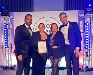 Puredrive Energy customer service team celebrating on stage